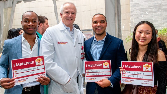 Medical students Ikenna Onyekwere (left), Branden Sosa (third from left) and Shuting Lu with Dean Robert A. Harrington.