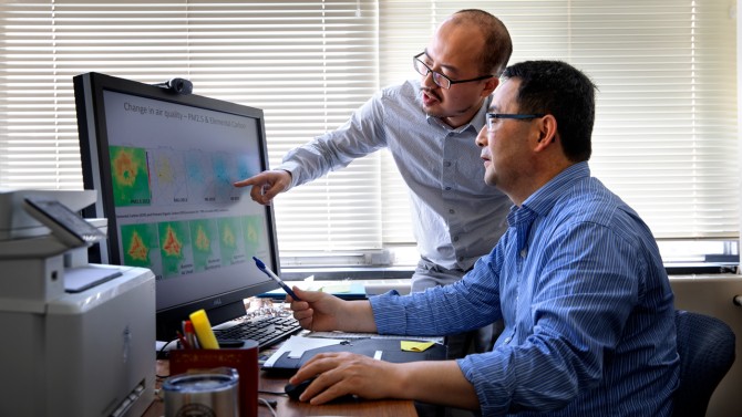Oliver Gao and Shuai Pan pore over research