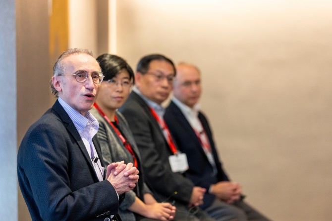 four people sit in a row for a panel discussion