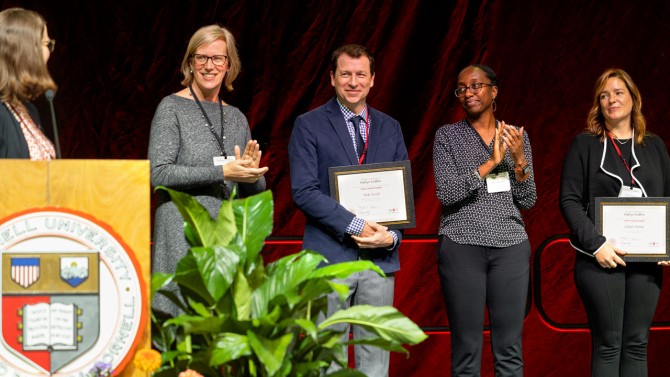Employees on stage receiving awards