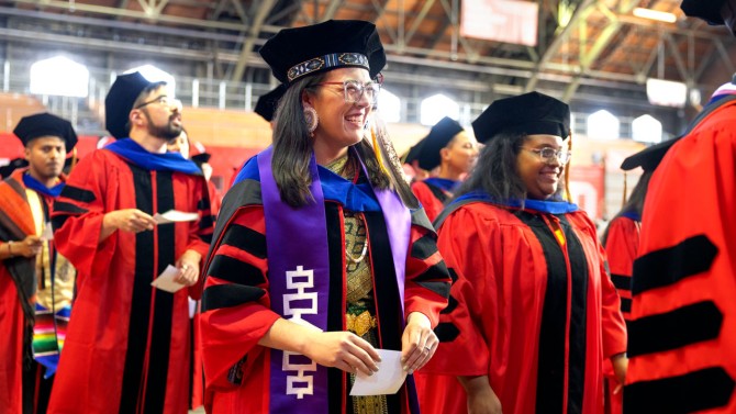 Ph.D. candidates prepare for recognition.