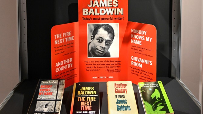 Closeup of a display of James Baldwin’s promotional materials and rare editions.